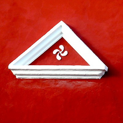 Ancient Basque lauburu on door lintel in Tixkokob, Yucatan